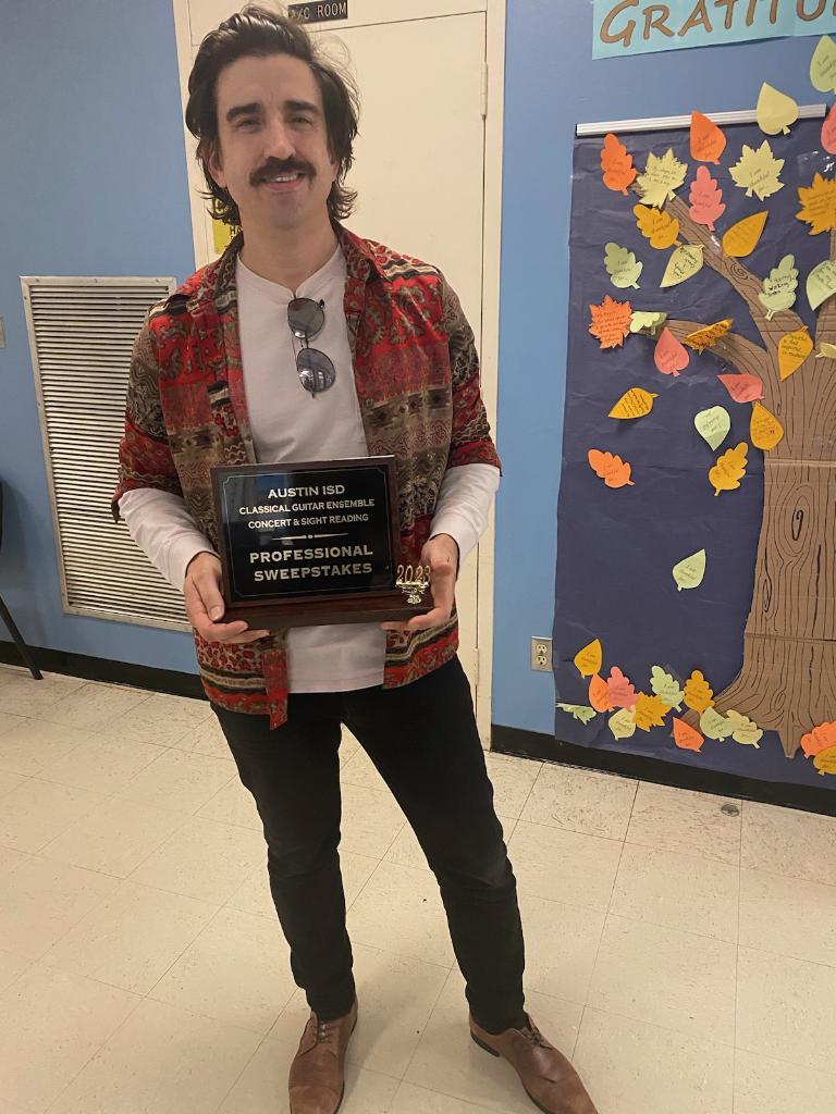 Mr. Shreve holding an award plaque.