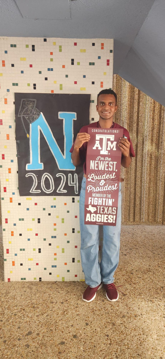 Preston Roberts holding Texas A&M banner.