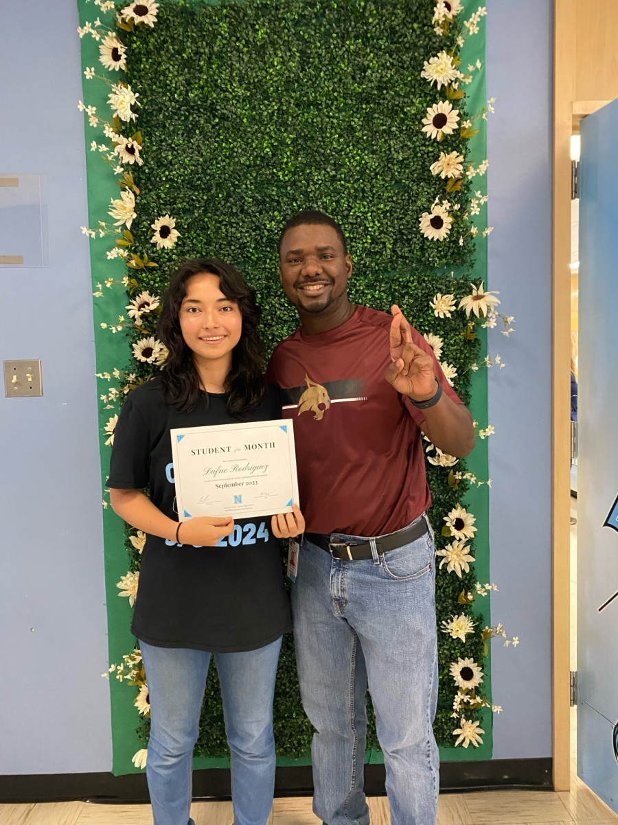 Dafne Rodriguez holding her Student of the Month certificate, next to Principal Neal.